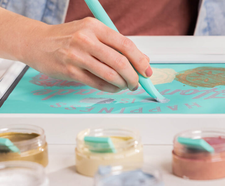 Closeup shot of woman using multi-tool to paste a transfer design.
